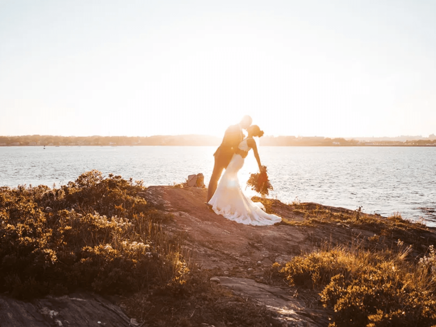 a man standing next to a body of water